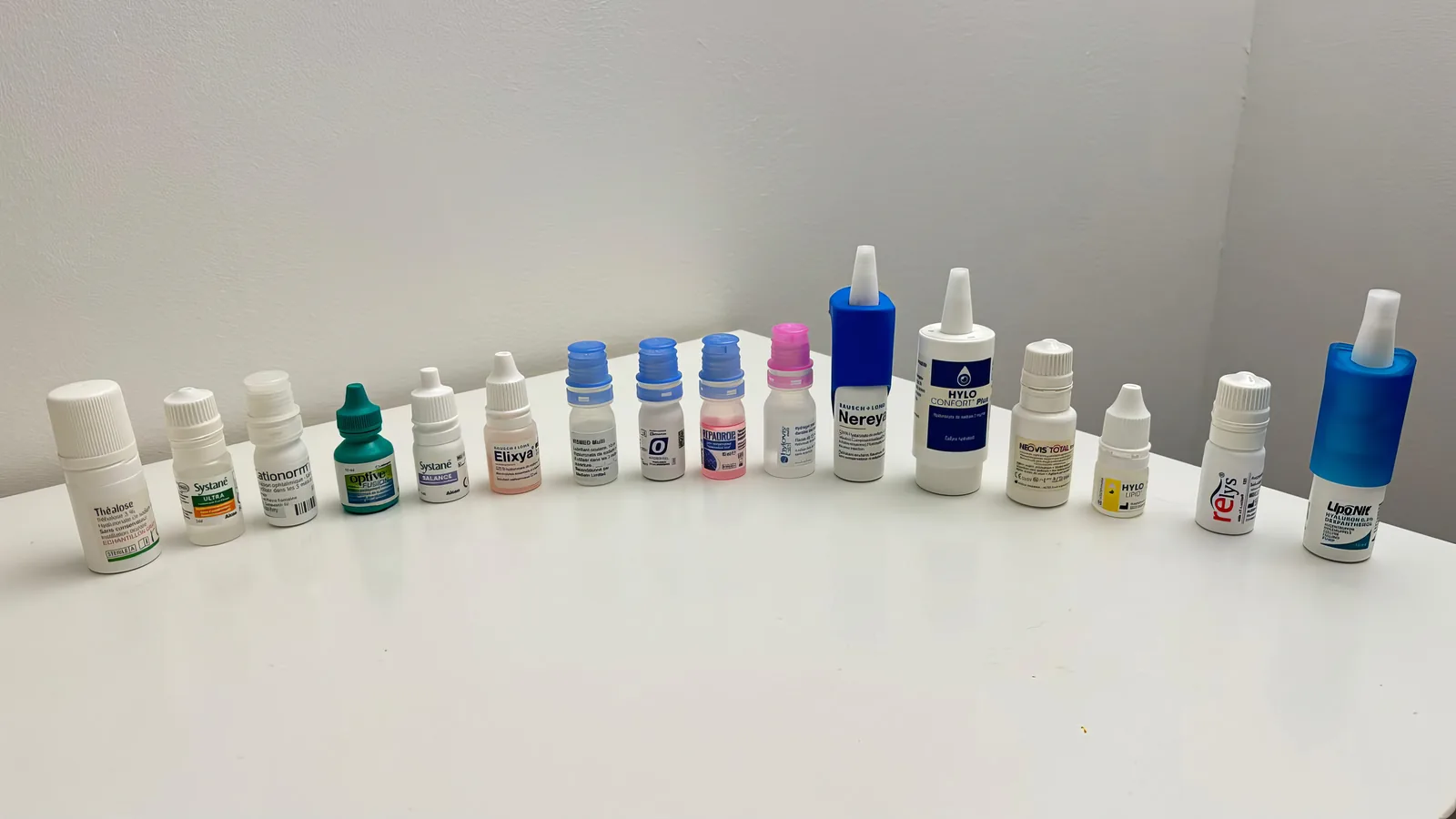 Assortment of lubricant eye drop bottles and single-dose vials illustrating different tear substitute formulations